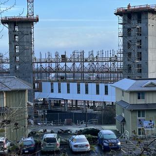 The housing tower construction with existing residences in front